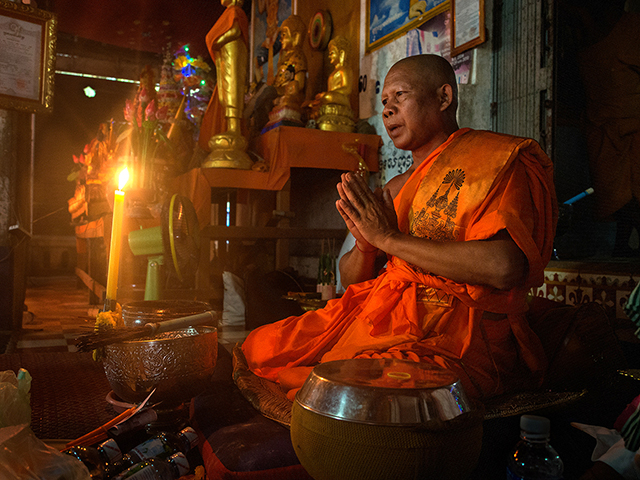 A monk praying near Angkor Wat     Olympus OM-D E-M1, 12-40mm f2.8