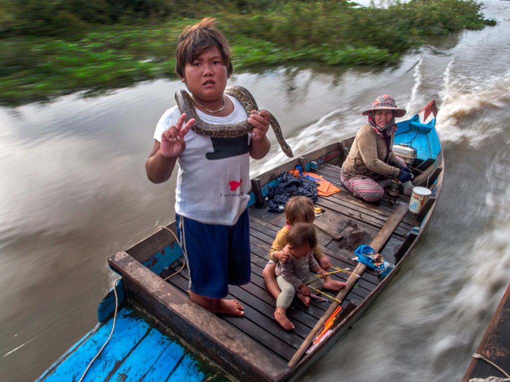 Floating city near Siem Reap, Cambodia, boy with snake    Olympus OM-D E-M1   9-18mm