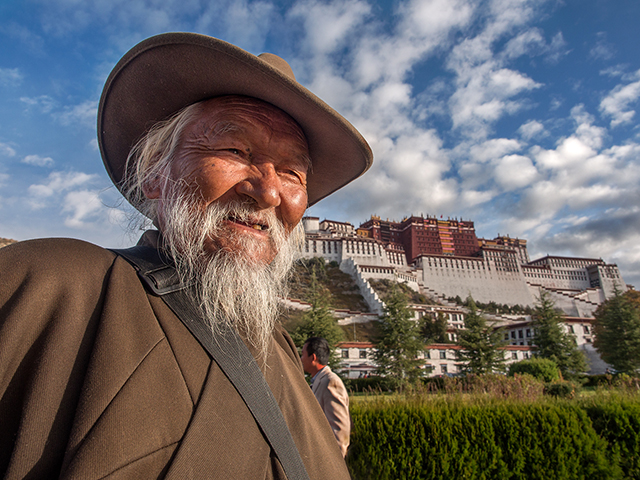 One of many Tibetans circling counter-clockwise around Patola Palace in traditional and daily ceremony   Oly OM-D E-M1  12-40mm f2.8