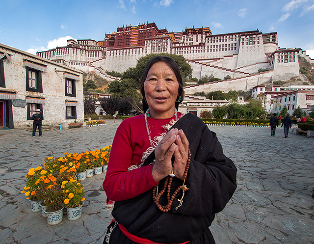 Buddhist woman from western Tibet mountain village with Potala Palace  Oly OM-D E-M1 12-40mm f2.8