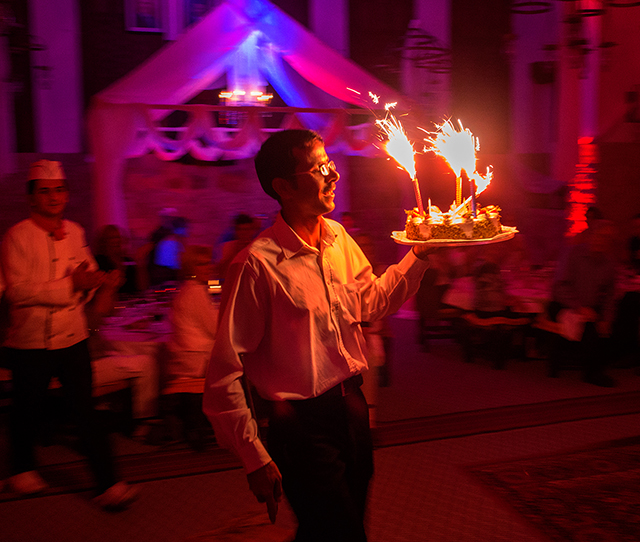 Birthday celebration, Jordanian waiter brings out cake with sparklers   OM-D E-M1  12-40mm  5000 ISO