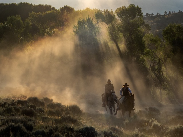 Two wranglers in the dust of the "Boneyard" morning horse drive.    Olympus E-M1 40-140mm f2.8