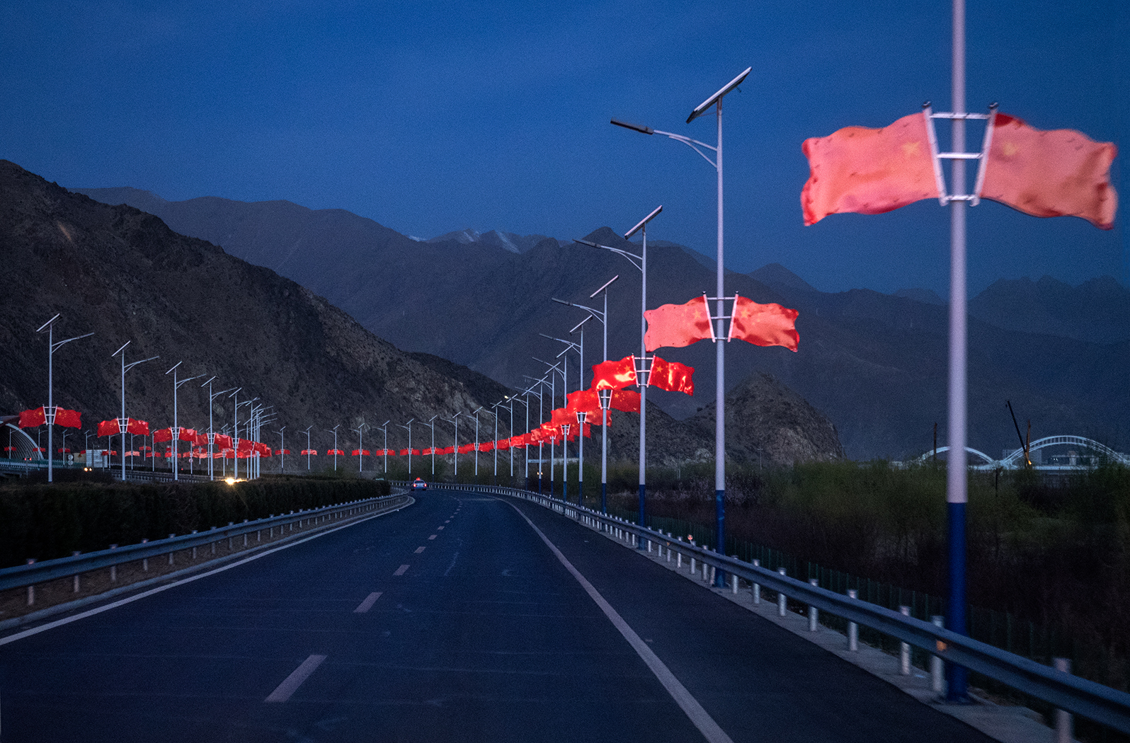 Chinese flags line the highway along highway in between Lhasa and airport in Tibet.
